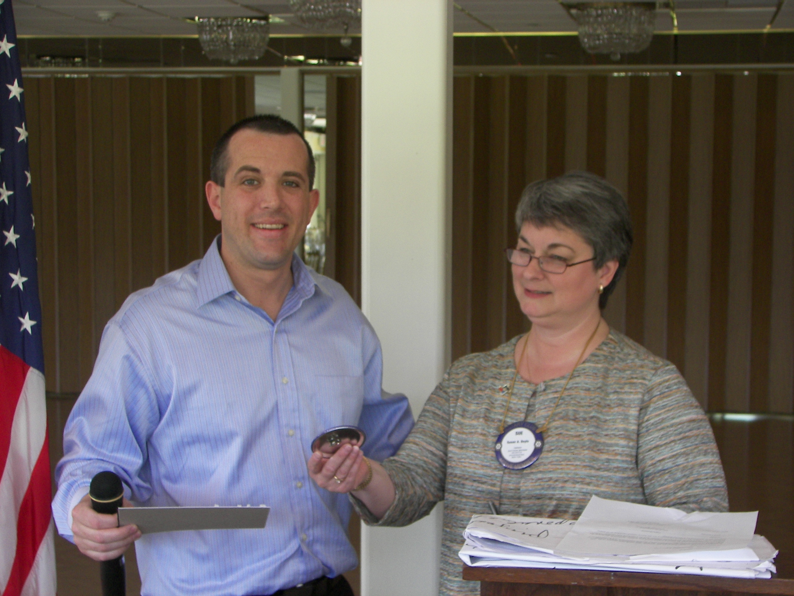 Dennis S. receiving
      his badge from President Sue D.
